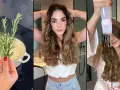 Preparando agua de romero para el pelo. Una mujer se aplica el tónico capilar con un aplicador especial.