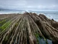 Dramatic rock formations on a rugged coastline, a perfect spot for day trips from Bilbao.