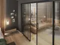 Nowoczesne rozwiązanie jak pogodzić salon z sypialnią: szklana, przesuwana ściana z salonu oddziela przytulną sypialnię z kanapą i łóżkiem.