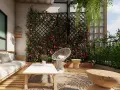 Un angolo relax con divano, tavolino e sedia, circondato da un rigoglioso muro giardino fiorito. Perfette idee muro giardino per un'oasi verde.