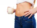 Donna con bicchiere di latte, un aiuto per sapere cosa bere la sera per andare di corpo.