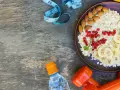 Zdrowa owsianka z owocami, orzechami, wodą i hantlami. Idealne śniadanie na białko na redukcji.