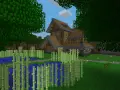 Drewniany dom z kamiennymi elementami, otoczony bambusami i wodą. W Minecraft można budować takie cuda i tworzyć własne światy.
