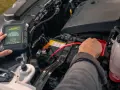 A person connects a Battery Tender jump starter to a car battery. This answers the question: do jump starters come charged?