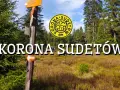 Droga przez malownicze **Sudety szczyty**, z oznaczeniami szlaku i logo "Korona Sudetów".