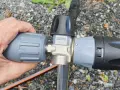 Hand connecting a Kärcher foam lance to a Kärcher K5 pressure washer.