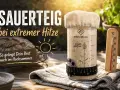 Sauerteig bei extremer Hitze: Ein Glas Sauerteig, ein Thermometer zeigt hohe Temperatur, Brot im Hintergrund. So gelingt Brot auch im Hochsommer.