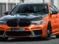 Pomarańczowe BMW M5 G-Power Hurricane RS z czarną maską i felgami.