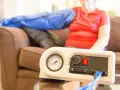 A person uses a lymphedema pump on their arm. Consult your doctor about how often you can use your lymphedema pump.