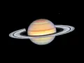 Saturn w Byku, majestatyczny gazowy olbrzym z pierścieniami, unoszący się w kosmicznej pustce.