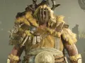 Un imponente druida de Diablo 4, con armadura de pieles y cuernos, listo para la batalla.