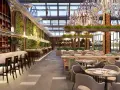 Elegante restaurante con barra de mármol, estanterías de vino, paredes verdes y exuberante vegetación, ideal para negocios de comida.
