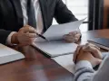 Prawnik omawia z klientem dokumenty dotyczące dziedziczenia z dobrodziejstwem inwentarza.
