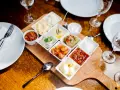 Meze-Platte mit verschiedenen Dips und Beilagen, wie Hummus und Salsa, serviert im Hasir Kreuzberg.