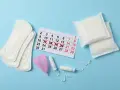 Kalender mit markierten Tagen, Binden, Tampons und Menstruationstasse. Fragen zu Zwischenblutung trotz Pille schwanger?