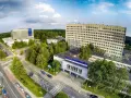 Widok z lotu ptaka na kompleks budynków szpitalnych otoczony zielenią.