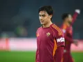 Piłkarz AS Roma w bordowej koszulce z pomarańczowymi pasami, gotowy do gry przeciwko Atalancie.