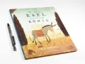 Der kleine Esel und der große König, inspiriert von Sacharja 9,9. Ein Buchcover mit einem Esel, der eine Decke trägt, und zwei Bäumen.