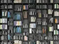 Eine Wand voller Bücherregale mit vielen Büchern in verschiedenen Farben und Größen.