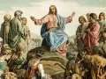 Jesus preaches the Beatitudes Catholic to a crowd gathered on a hillside, his arms outstretched in blessing.