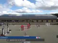 Daniel Dormaels et son cheval 25 - Bandro Boy de Bethune s'élancent sur la piste d'obstacles sous un ciel nuageux.