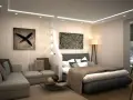 Ett modernt sovrum i vardagsrummet, avskilt med en dekorativ vägg. En bekväm soffa och en inbjudande säng skapar en mysig atmosfär.