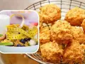 Polpette al forno dorate e croccanti, accanto a una ciotola di muesli, frutta e un metro da sarta, per un pasto sano e gustoso.