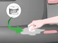 A hand applies car wax to a gray surface, showing how to remove scratches from clear plastic.