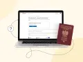 Laptop z otwartą stroną gov.pl o paszportach i polski paszport obok. Wniosek o paszport w Łodzi? Sprawdź, jak go uzyskać online.