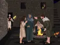 A man with a torch approaches a group gathered around a fire. Blessed are those who are persecuted for righteousness' sake.