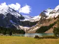 Majestuoso ibón de Plan, rodeado de montañas nevadas y bosques. Un paisaje perfecto para una ruta circular.