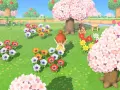 Una jugadora de Animal Crossing New Horizons admira un campo de flores de cerezo y anémonas de colores.