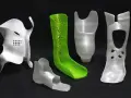 A collection of orthopedic devices, including braces and prosthetic components, showcase the versatility of polypropylene 3D printing.