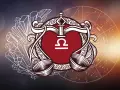 Symbol Wagi (23 września - 22 października) w ozdobnej ramce, otoczony kryształami i kołem zodiaku.