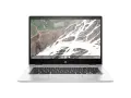 Srebrny laptop HP z systemem **Chromium OS** i klawiaturą. Na ekranie widok z lotu ptaka na krajobraz.