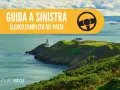 Guida a sinistra paesi: elenco completo. Paesaggio costiero con faro e case su una scogliera verde.