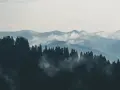 Mgliste góry sowie, zalesione zbocza i doliny, tworzą malowniczy krajobraz.