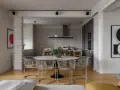 Nowoczesne wnętrze z okrągłym stołem i krzesłami w stylu bauhaus. W tle kuchnia i abstrakcyjne obrazy.