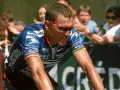 Lance Armstrong, in his USPS jersey, strains during a race, a stark image given how Lance Armstrong cheated his way to victory.