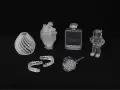A collection of 3D printed acrylic objects: a vase, heart, dental aligners, perfume bottle, rose, and astronaut.