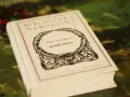 Biała księga z napisem "Emily Dickinson Wybór Poezji" w ozdobnej ramce.