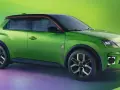 Zielony samochód elektryczny Renault 5 z czarnym dachem i czerwonymi akcentami.