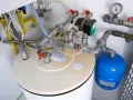 Le chauffe-eau qui explose par le haut, avec ses tuyaux et sa pompe, semble prêt à déborder.