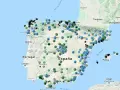 Mapa de España con puntos de colores que indican niveles de contaminacion atmosferica.
