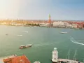 Vista aerea di Venezia con il Canal Grande, imbarcazioni e la famosa arte della città sullo sfondo.