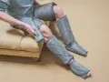 Man using a leg compression machine, enjoying the benefits of improved circulation and muscle recovery.