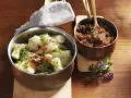 Ein köstliches Haferwurzel Rezept mit karamellisierten Zwiebeln und frischem Schnittlauch. Serviert in Kupfer- und Edelstahlschalen auf einem Holztisch.