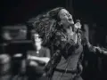 Energetyczny alanis morissette koncert, wokalistka śpiewa z pasją, włosy rozwiane w locie.