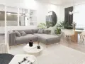 Soggiorno moderno con divano grigio, tavolino rotondo e cucina a vista. L'arredamento minimalista e i toni neutri evocano un caldo **stile nordico**.