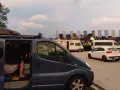 Na parkingu przy Chochołowskich Termach stoi ciemnoniebieski bus, biały samochód i kamper.